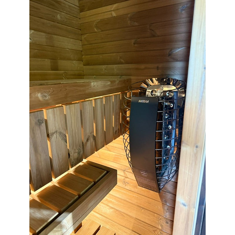 Innenansicht der Celsium Ula Mini Sauna mit Harvia Saunaofen und dunkler Holzverkleidung – hochwertige Ausstattung und stimmungsvolle Beleuchtung