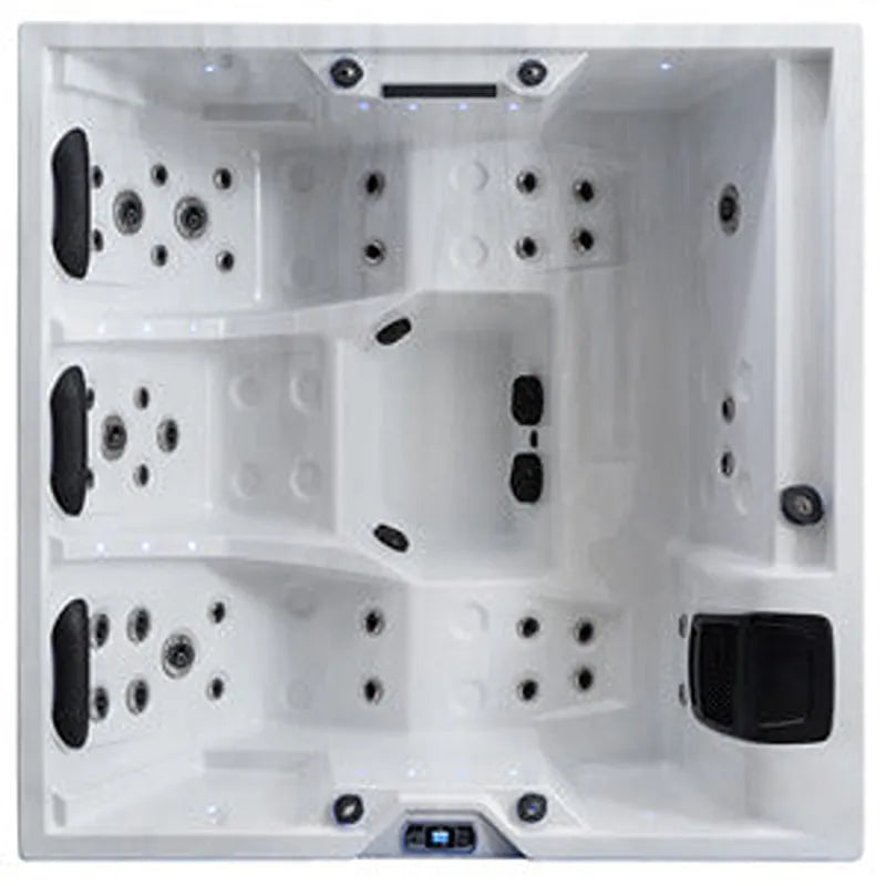 Draufsicht auf den EAGO AWT IN-402 extreme pro Outdoor Whirlpool mit quadratischem weißem Becken, zahlreichen Massagedüsen und schwarzen Bedienblöcken an den Seiten