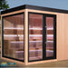 Freistehende Designsauna THE CUBE X7-L mit Panoramaverglasung und klarer Architektur im Außenbereich