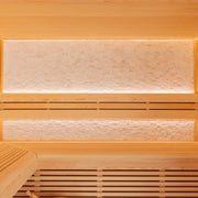 Innenansicht der AWT E1812C Sauna aus Pinienholz mit zwei beleuchteten Bänken und sichtbarem Saunaofenbereich unten links