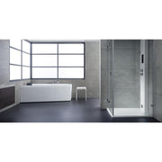 Modernes Badezimmer mit weißer Eckbadewanne EAGO AWT GE105E und bodenebener Dusche mit Glastüren, Betonoptik-Wänden und großem Fenster.