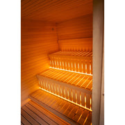 Zweistufige Saunabänke aus hellem Holz mit warmer indirekter Beleuchtung.
