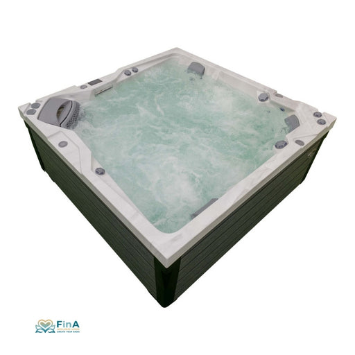 JJSpa Alpha 923 Premium Whirlpool mit weißem Rand und grüner Holzumrandung, sprudelnd gefüllt mit türkisem Wasser, Draufsicht