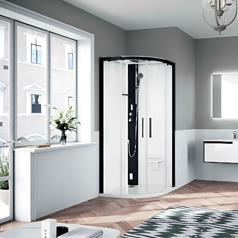 Novellini Glax 1R Dampfdusche Schwarz Matt – stilvolle Runddusche mit Glasfront in elegantem Badezimmer bei gedämpfter Beleuchtung.