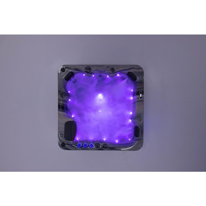 Platinum Spas Refresh Outdoor Whirlpool – Deluxe, für bis zu 6 Personen, Farbe: Odyssey. Draufsicht mit lila LED-Beleuchtung bei aktivierten Massagedüsen.