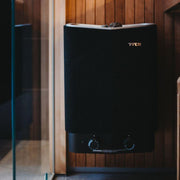 Tylö Sense Sport Compact Saunaofen in Schwarz mit weißer Oberkante und integrierten Bedienreglern in moderner Saunakabine aus Holz