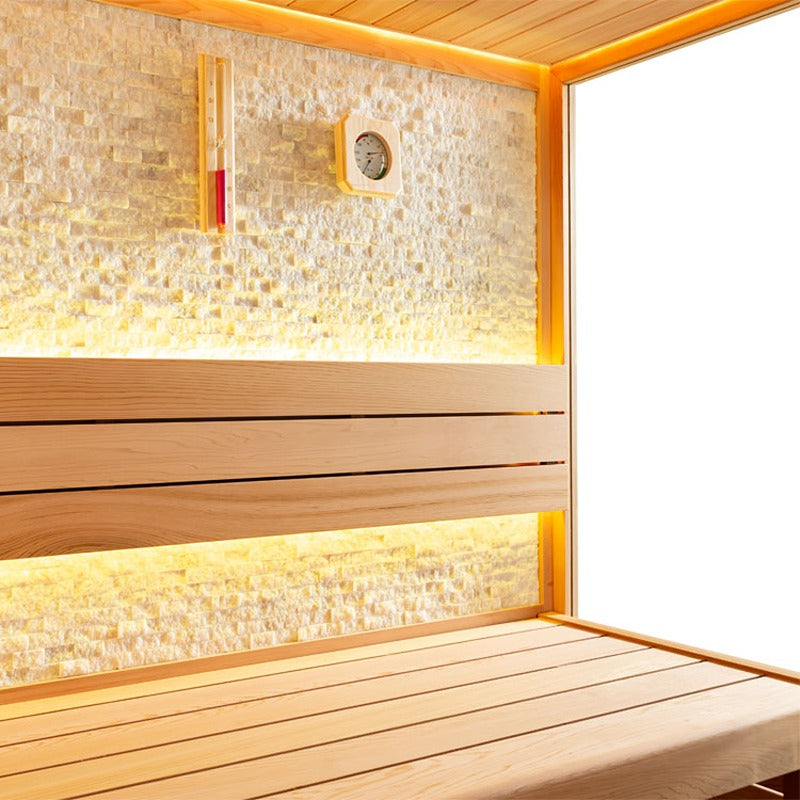 Naturstein-Rückwand der AWT E1601B Sauna mit warmer LED-Beleuchtung und Holzrückenlehne aus roter Zeder