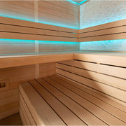 Modernes Saunainneres mit hellen Holzbänken, türkiser LED-Beleuchtung an Wänden und Decke, natürliches Lärchensperrholz, Design der AWT E1602C