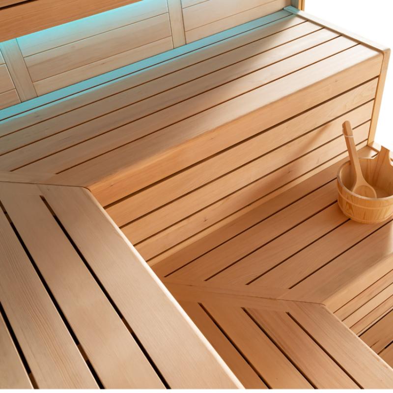 Innenraum der EAGO AWT E1613B Hemlock Sauna mit hellen Holzbänken, Rückenlehne und Saunazubehör-Eimer, türkisfarbenes Fenster im Hintergrund