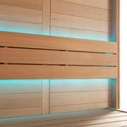 Modernes Saunainnenraum aus hellem Hemlock-Holz mit blauer LED-Beleuchtung, zwei Liegebänke und Rückenlehnen, zeitloses Design der EAGO AWT E1613C
