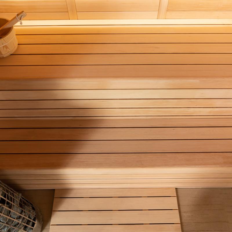 EAGO AWT E1624B Hemlock Sauna Innenraum mit Holzbänken aus hellem Fichtenholz, warme Lichtverhältnisse