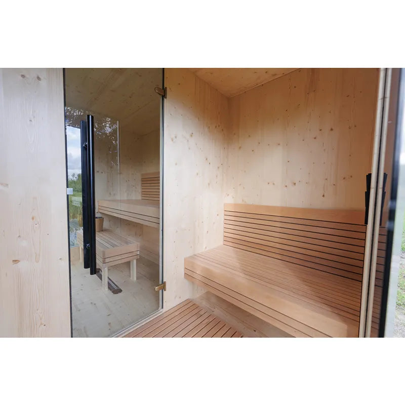 Genevas Zermatt Modular Sauna Compact mit Holzverkleidung und großen Glasfenstern in Gartenlandschaft