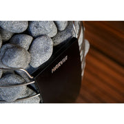 Close-up of the Harvia Spirit sauna heater with natural stones and black front panel