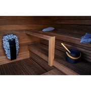 Harvia Spirit Sauna heater with sauna stones - integrated in an elegant wooden sauna, with sauna bucket and ladle as accessories