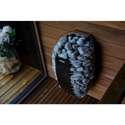 Harvia Spirit wall heater mounted in a modern wood-burning sauna, side view