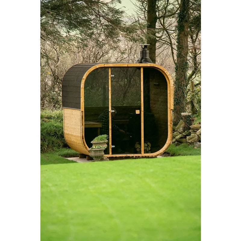 Hekla Cube 160/210/250 Gartensauna mit Holzverkleidung und großen Glasfenstern im grünen Garten