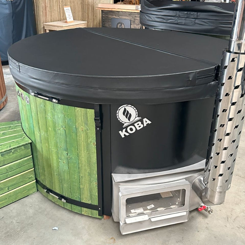 Koba Hot Tub BASIC Whirlpool mit grüner Holzverkleidung und schwarzem Deckel, Feuerbox sichtbar, Ausstellungsansicht