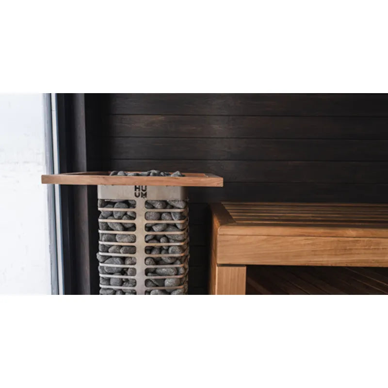 HUUM Elektrischer Saunaofen STEEL mit Holzabdeckung und Steinen in moderner Sauna