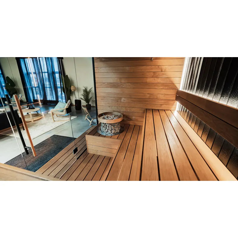 Huum Hive Mini elektrischer Saunaofen in moderner Innensauna mit Holzbänken und Saunasteine