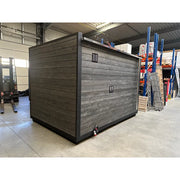KOBA Cube Gartensauna mit moderner quadratischer Form, dunkelgrau geölt, in Lagerhalle