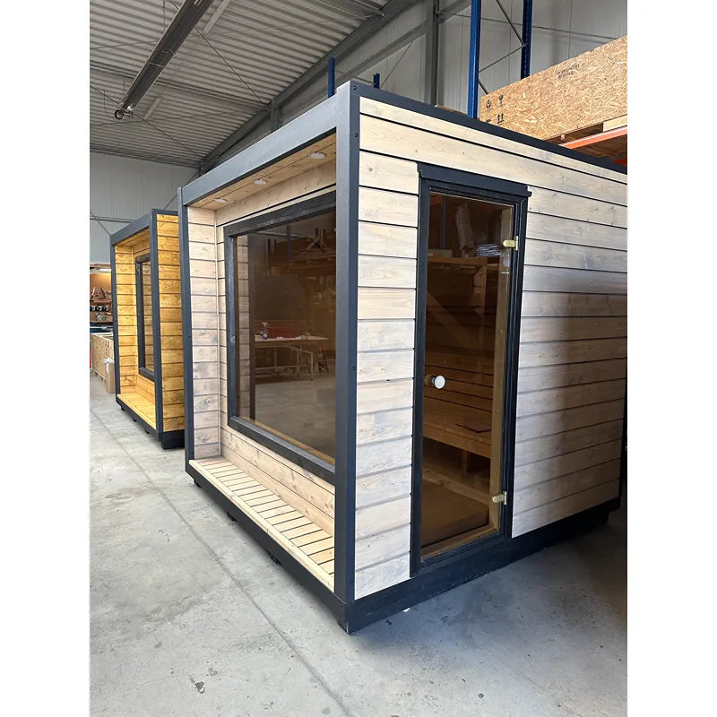 KOBA Cube Gartensauna - Moderne quadratische Form mit Holzverkleidung und großem Fenster in Werkstatt