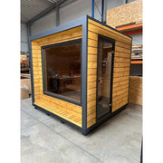 KOBA Cube Gartensauna - Moderne quadratische Form mit Holzverkleidung und großem Fenster in Lagerhalle