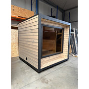 KOBA Cube Gartensauna - Moderne quadratische Form mit Holzverkleidung und großem Fenster in Lagerhalle