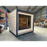 KOBA Cube Gartensauna - Moderne quadratische Form mit Holzverkleidung und großem Fenster in Werkstatt