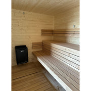 KOBA Cube Gartensauna Innenraum mit Holzbänken und Harvia Ofen