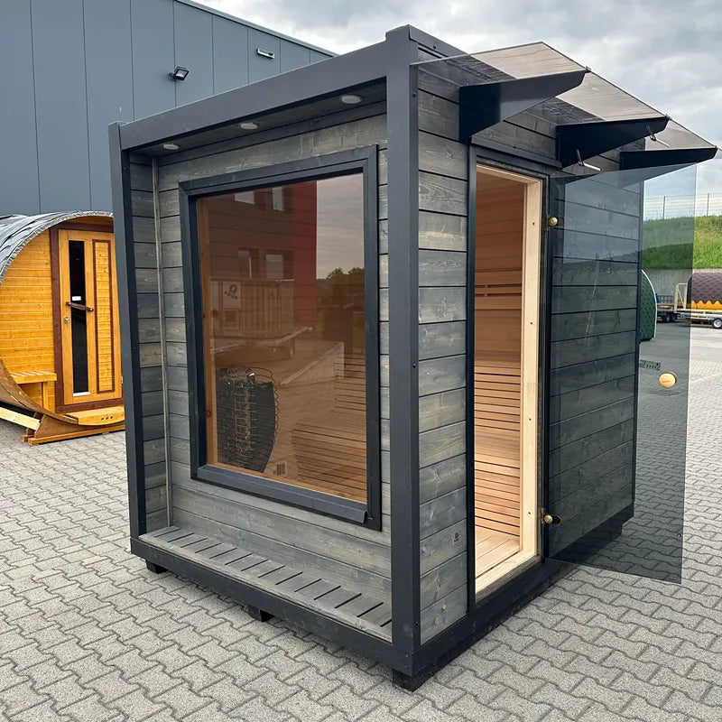 KOBA Cube Gartensauna - Moderne quadratische Form mit schwarzem Holzrahmen, großem Panoramafenster und heller Holzinnenausstattung