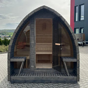 KOBA Iglu Gartensauna mit charakteristischer Iglu-Form, dunkelgrau, Frontansicht mit offener Tür und Holzinnenausstattung