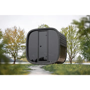 Leil Black Cube Classic Gartensauna 4 Personen von Leil Saunas im Garten mit modernem schwarzem Design und großen Fenstern