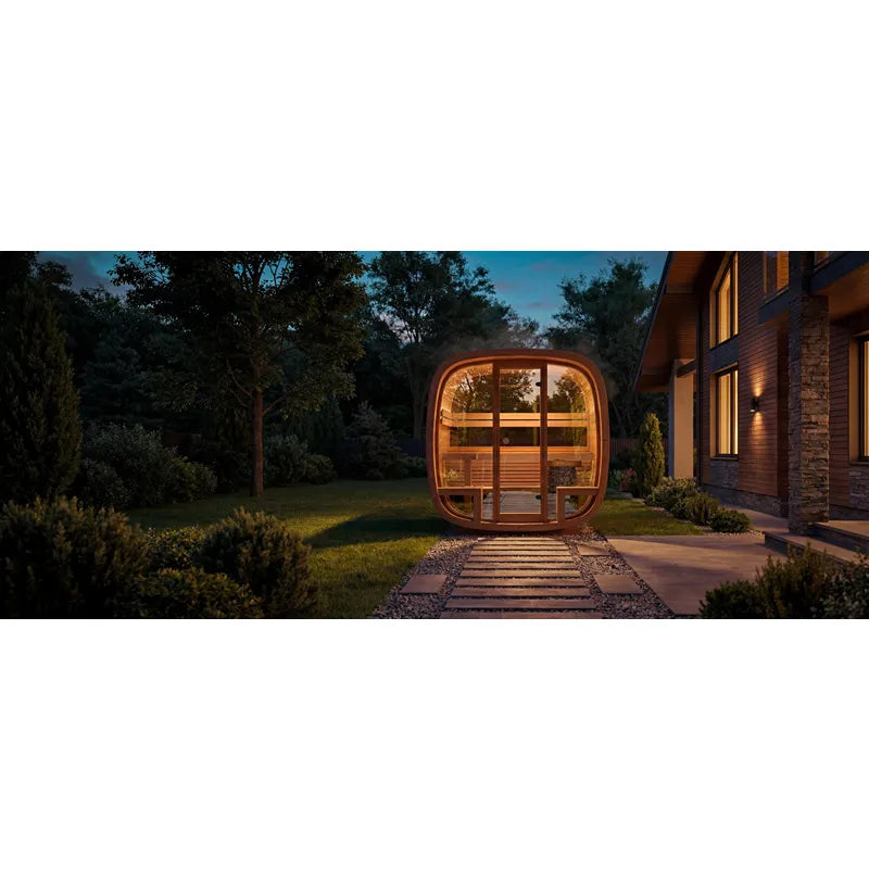 Leil Dice Comfy Gartensauna 4 Personen 2 Räume von Leil Saunas, beleuchtet im Garten bei Dämmerung