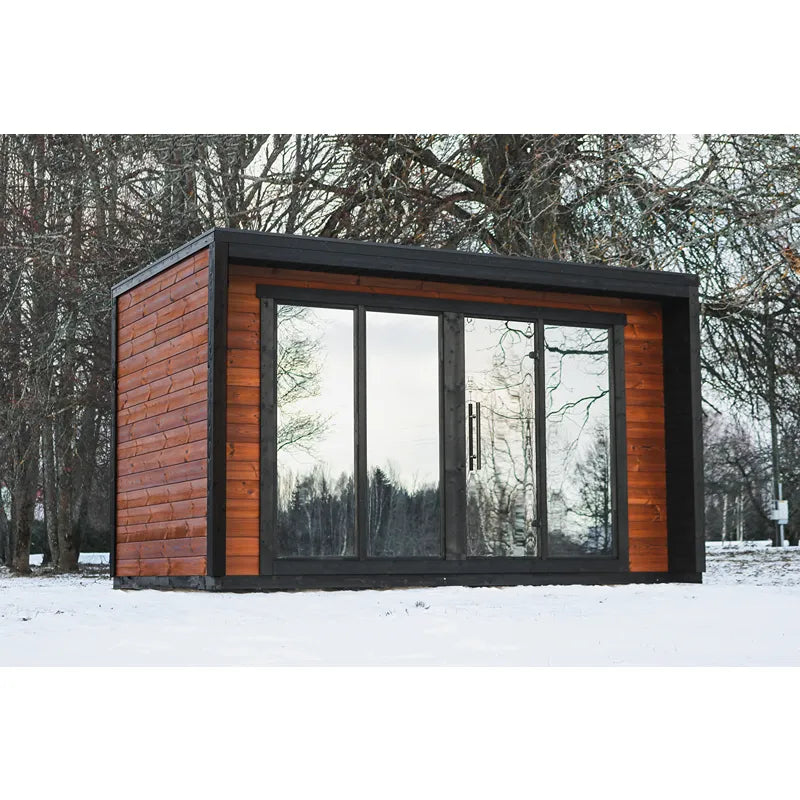 Leil® Patio L Gartensauna von Leil® Saunas mit Holzverkleidung und großen Glasfenstern im verschneiten Garten