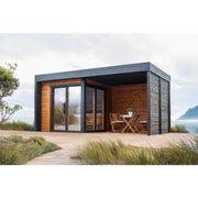 Leil Patio S Plus Gartensauna mit Überdachung von Leil Saunas in modernem Design mit großem Glasfront am Strand