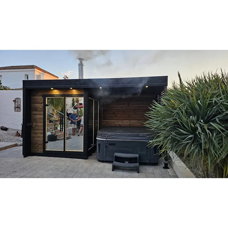 Leil Patio S Plus Gartensauna mit Überdachung im Garten mit schwarzer Holzfassade, Glastür und integriertem Whirlpool