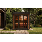 Leil® Patio XS Gartensauna von Leil® Saunas mit Holzverkleidung und großen Glastüren im Garten, wärmend beleuchtet