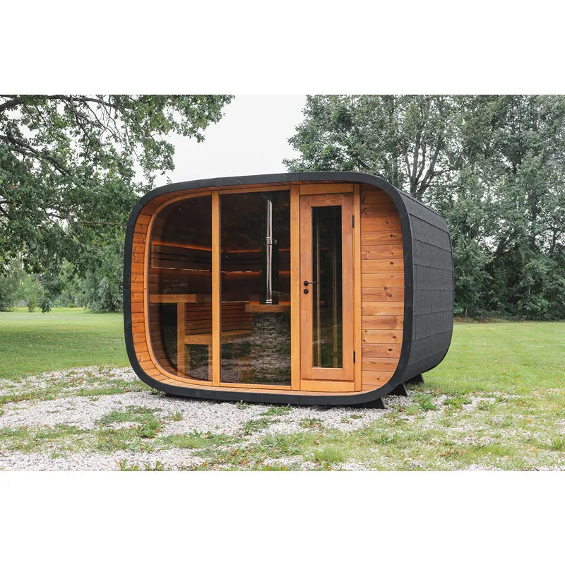 Leil® Round Cube Double Premium Gartensauna 2 Räume mit rundlicher Form, Holzfront und dunklem Außenbereich im Garten