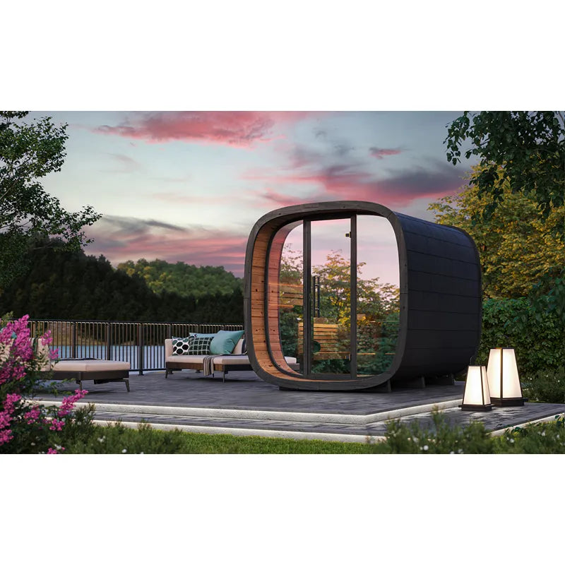Leil Round Cube Mini – Gartensauna 4 Personen von Leil Saunas mit schwarzem Außendesign und großem Glasfenster, installiert in modernem Gartenambiente bei Sonnenuntergang