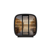 Leil Round Cube Mini Gartensauna 4 Personen von Leil Saunas mit schwarzem Rahmen und Glastür, Holzinnenausstattung sichtbar