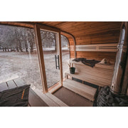 Leil Round Cube Single Premium Gartensauna Innenraum mit Holzbänken, großen Glasfenstern und Gartenblick