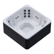Novitek M-0 Outdoor Whirlpool in Weiß und Schwarz mit quadratischem Design, ausgestattet mit mehreren Massagedüsen an allen Seiten, von oben betrachtet