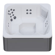 Draufsicht auf den Novitek M-0 Outdoor Whirlpool mit weißem Innenbecken, mehreren Düsen an den Seitenwänden, Sitzplätzen und grauem Außengehäuse.