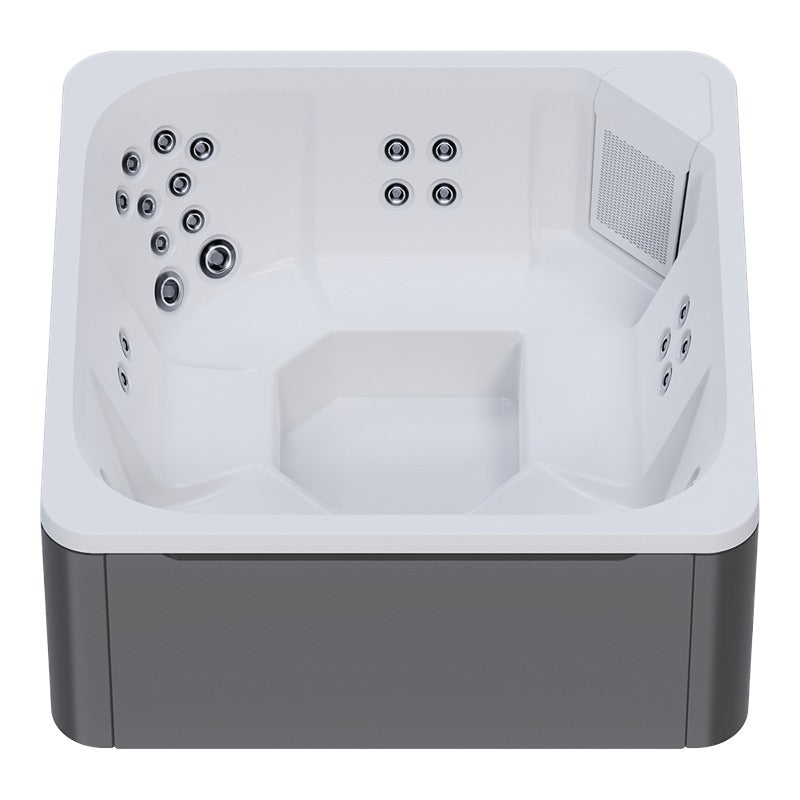 Draufsicht auf den Novitek M-0 Outdoor Whirlpool mit weißem Innenbecken, mehreren Düsen an den Seitenwänden, Sitzplätzen und grauem Außengehäuse.