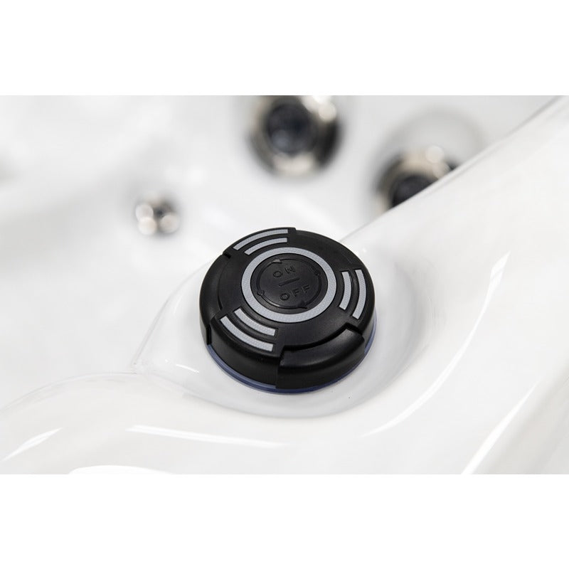 Platinum Spas Happy Whirlpool – Nahaufnahme des schwarzen ON/OFF-Drehreglers auf weißer Acryloberfläche