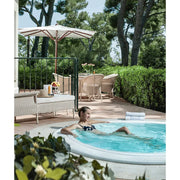 Portcril Club 28 Overflow Spa 9-Personen Whirlpool in Gartensetting mit Frau beim Entspannen
