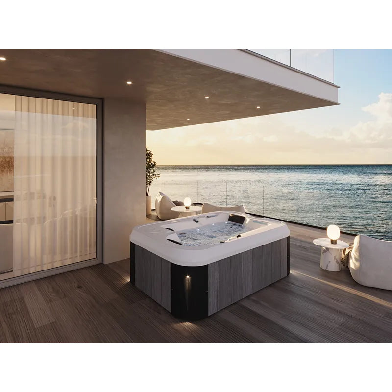 Portcril Essential 2 Spa 2-Personen Whirlpool mit weißem Becken auf moderner Terrasse mit Meerblick