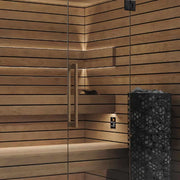 Termo Pure Innensauna von Savne Štrus mit wärmebehandeltem Holz, Innenraum mit Holzbänken und schwarzem Saunaofen