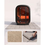 Swedish Cold Private Escape Gartensauna 2 Personen 90°C mit schwarzem Rahmen und glühenden Infrarotheizern auf Terrassenfliesen