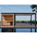 Außensauna THE CUBE X7-L pro von AWT mit integrierter Pergola und vollverglaster Front – modernes Outdoor-Wellnessdesign am Wasser.